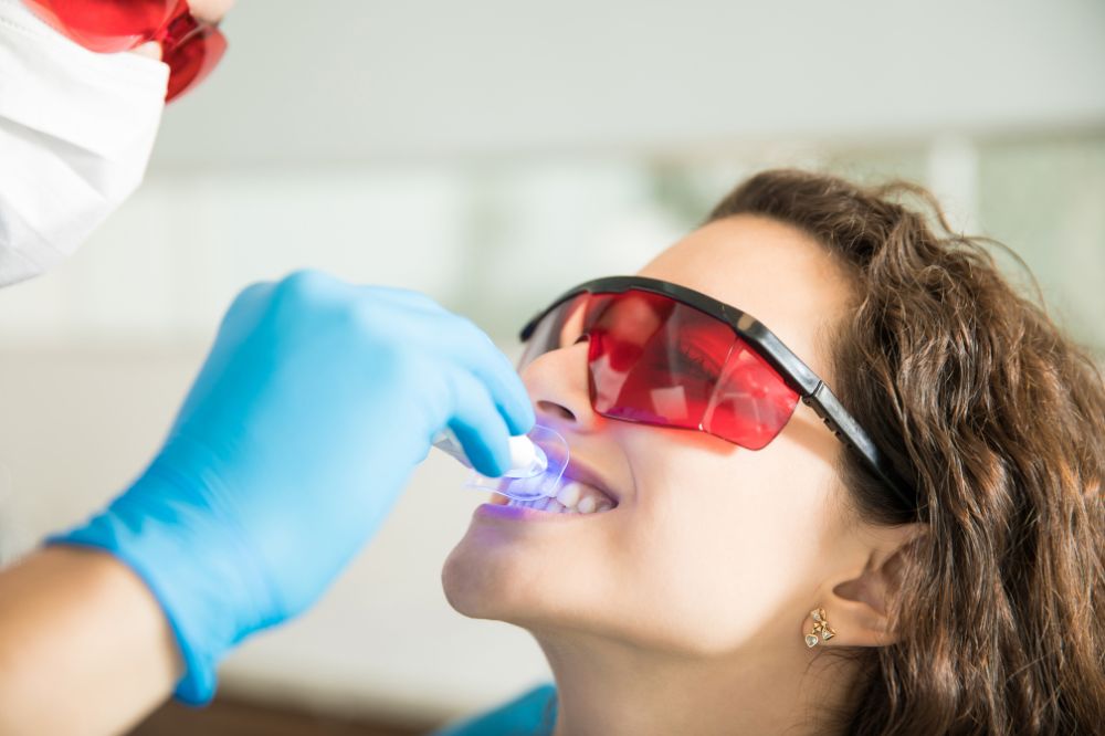 a woman is getting dental treatment.